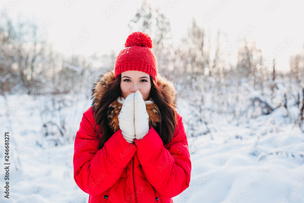 Portrait of young beautiful woman on winter outdoor background Portrait of young beautiful woman on winter outdoor background