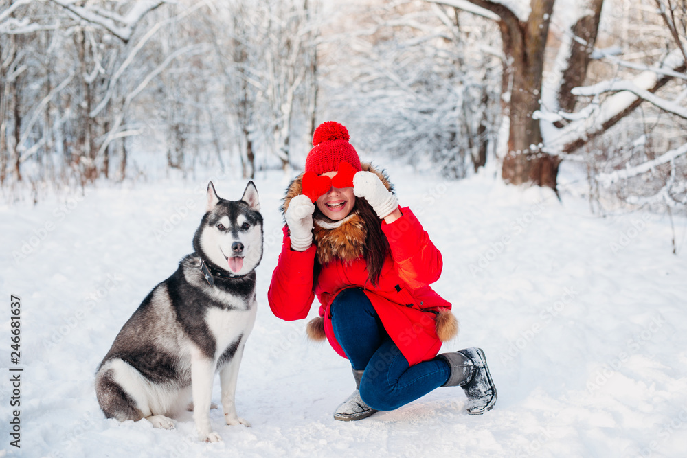 Young girl with her husky dog in winter park. Domestic pet. Husky Young girl with her husky dog in winter park. Domestic pet. Husky