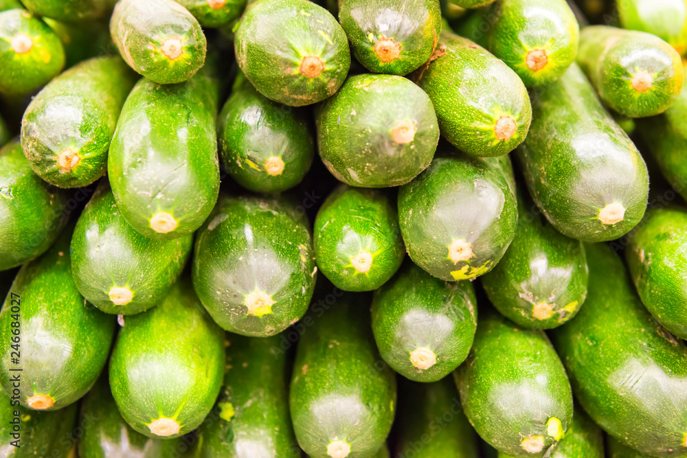 Pile of green zucchini at vegetable market Pile of green zucchini at vegetable market