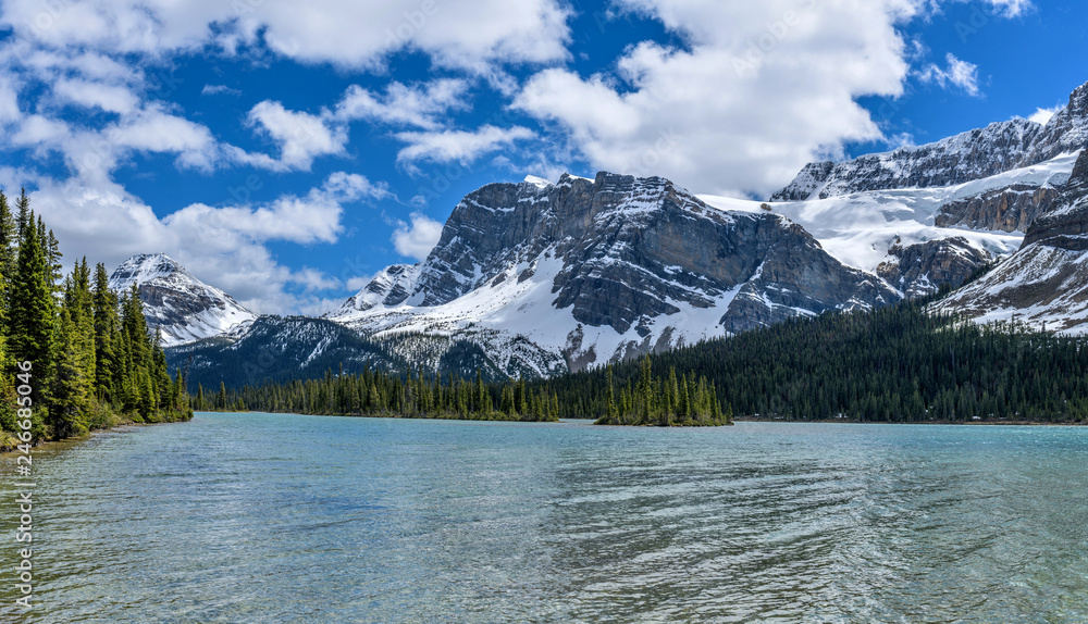 Mountain, Glacier and Lake - A panoramic Spring view of Bow Peak (left), Bow Crow Peak (center) and Crowfoot Glacier (right) at shore of Bow Lake, Banff National Park, Alberta, Canada.