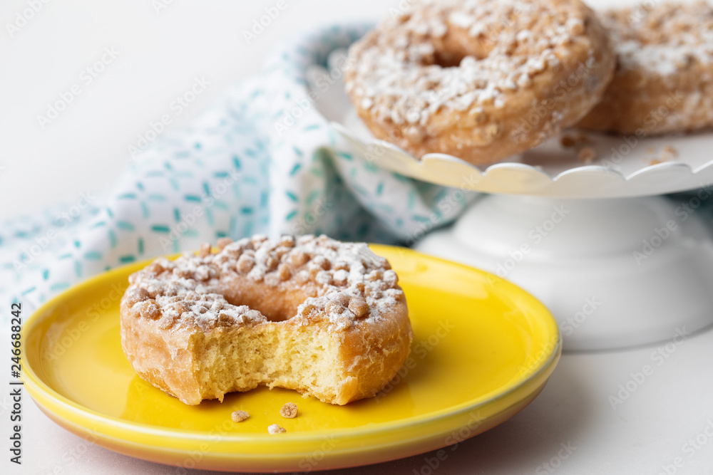 Bite Out of a Donut on a Yellow Plate Bite Out of a Donut on a Yellow Plate