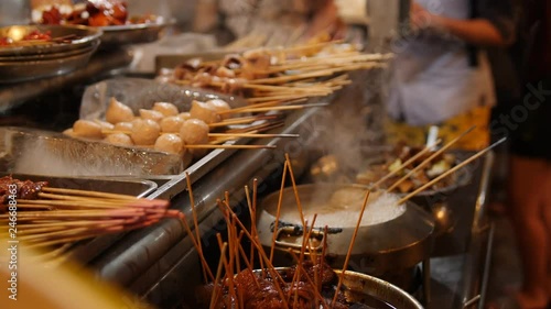 Traditional Asian Street Food Barbecue Satay on Wooden Stick at Night Market. 4K Slowmotion Cinematic Footage.