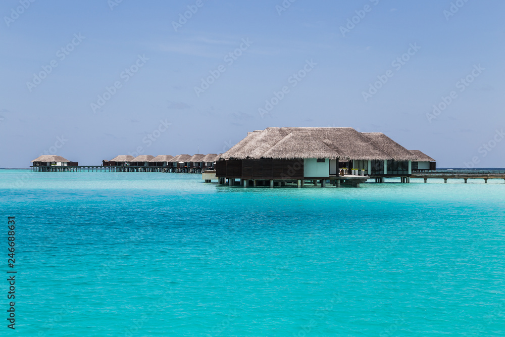 Water villas on the clear blue beach in the Maldives
