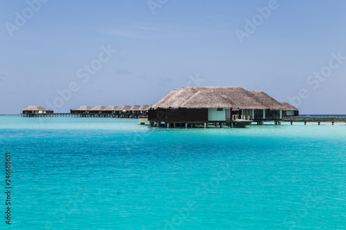 Water villas on the clear blue beach in the Maldives © bluesnaps