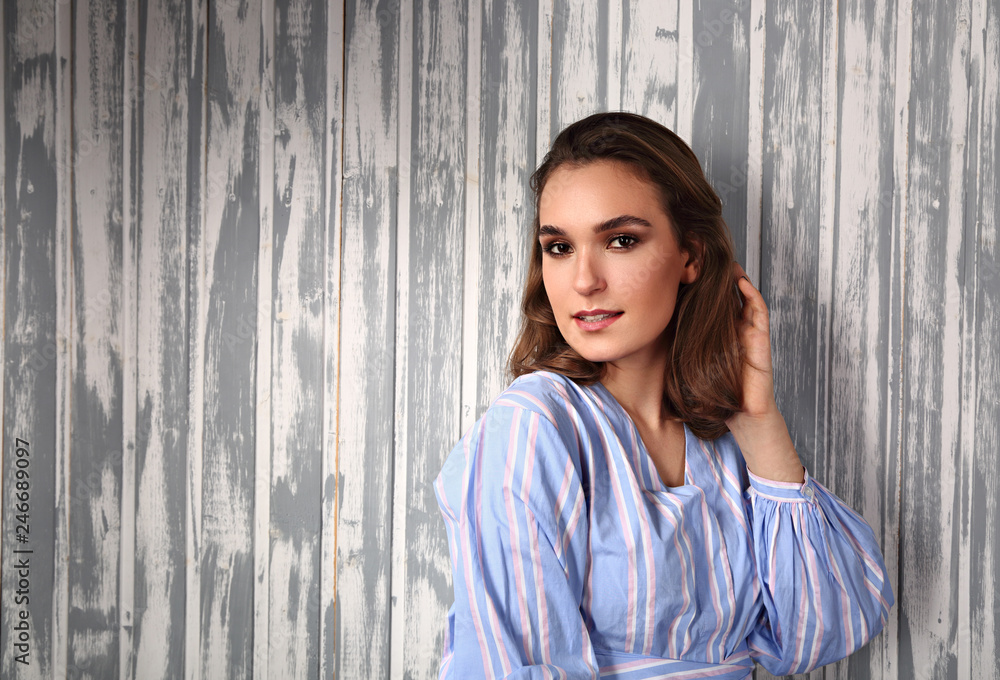 Beautiful positive young happy woman thinking and looking in casual blue shirt and short hair stye Beautiful positive young happy woman thinking and looking in casual blue shirt and short hair stye