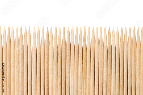 Bamboo toothpicks are placed in parallel - backgrounds, textures. Bamboo toothpicks isolated on white background photo