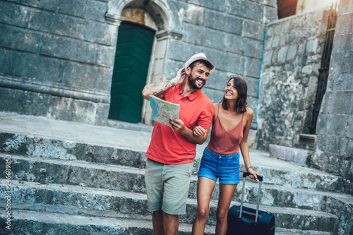 Traveling couple of tourists walking around old town. Vacation, summer, holiday, tourism: concept.