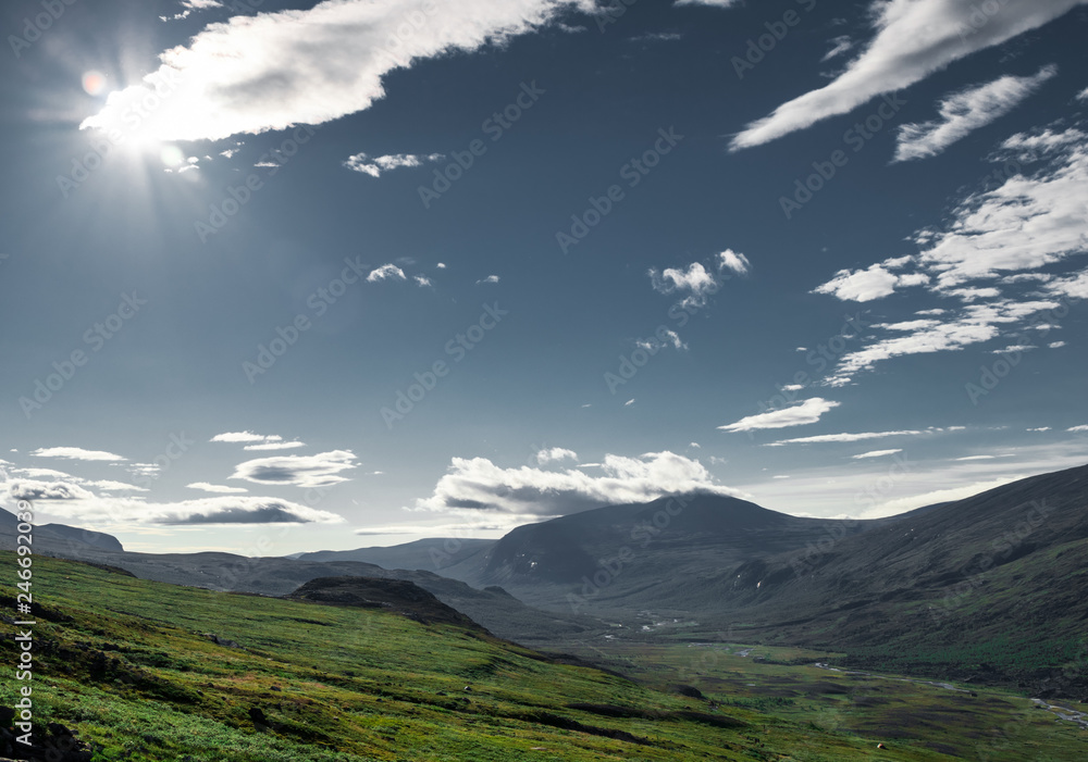 Sun shining through a cloud overlooking the valley at Kebnekaise mountain station. Shot on the way to hike up Kebnekaise mountain. 