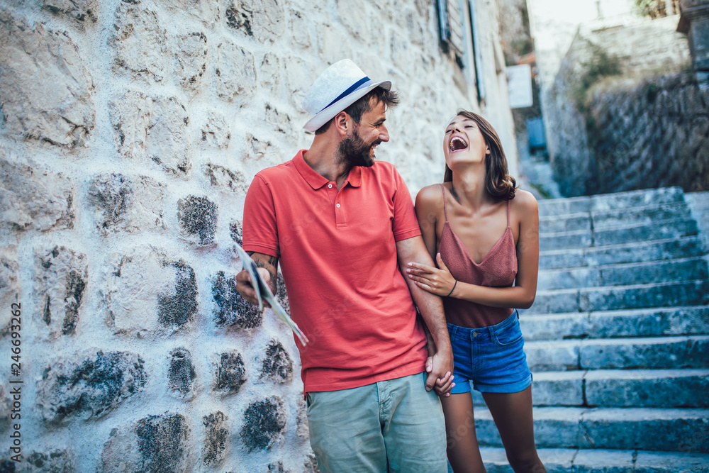 Traveling couple of tourists walking around old town. Vacation, summer, holiday, tourism: concept. Traveling couple of tourists walking around old town. Vacation, summer, holiday, tourism: concept.