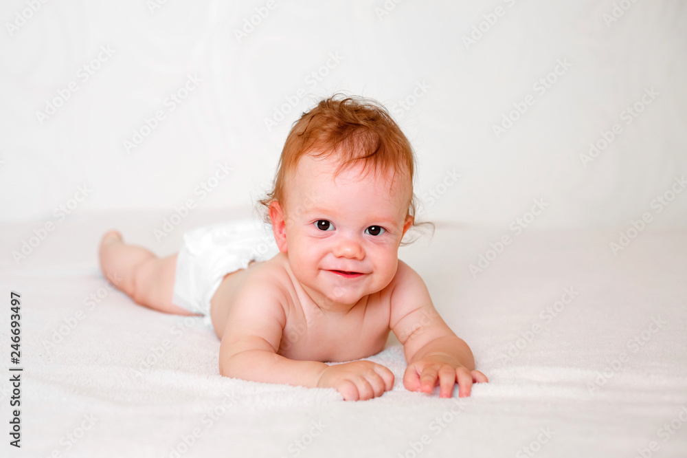Portrait of cute redhead infant baby in diaper in light bedroom. Family, motherhood, love, health, innocence and care Portrait of cute redhead infant baby in diaper in light bedroom. Family, motherhood, love, health, innocence and care