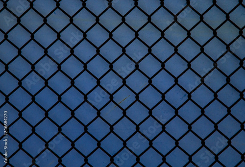 Old, rusty, chain-link fence.