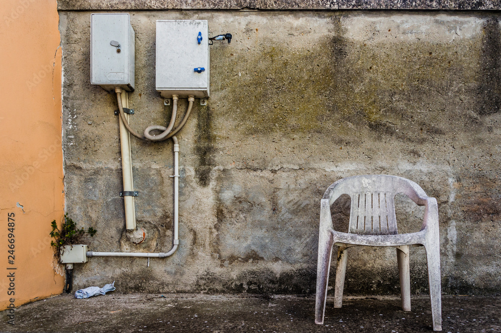 Abandoned old plastic empty chair, conceptual photo Abandoned old plastic empty chair, conceptual photo