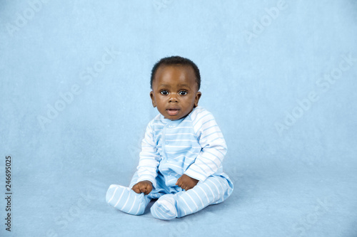 Sitting Up Adorable African American Baby Boy on a Blue Background