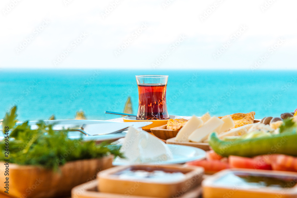 Fototapeta premium Breakfast on the beach at hotel or resort by the sea in summer season. Holiday and vacation breakfast image.