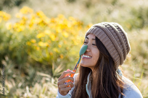Woman smiling with a spoon on her nose