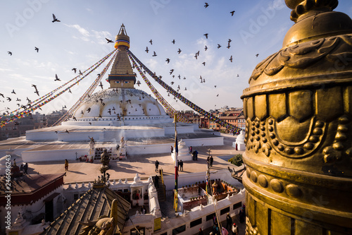 Birds flock around The Boudhanath Buddha Stupa temple in Kathmandu