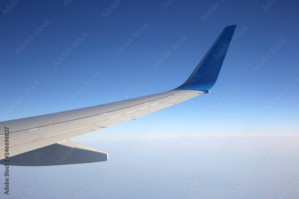 The wing of an airplane above the clouds The wing of an airplane above the clouds