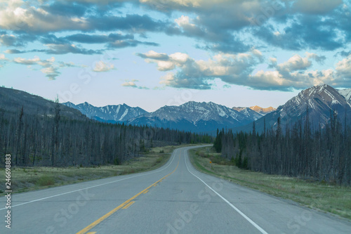 Straight road ahead in the Canadian Rockies along the Icefields parkway in Alberta, Canada