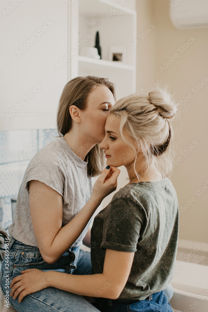 Beautiful girls in love kiss in the kitchen Stock Photo | Adobe Stock
