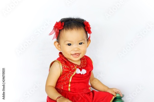 Chinese New Year festival concept, a Chinese 's baby girl in the red clothes. She holding a pocket money gift in her hand. On white background.