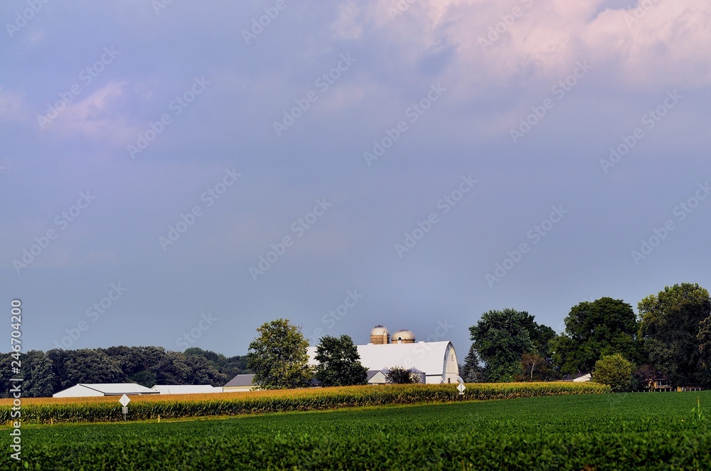 A summer storm builds above a country road and farm in northeastern Illinois. Late afternoon and evening thunderstorms are common in the Midwest as heat and humidity build throughout the day..