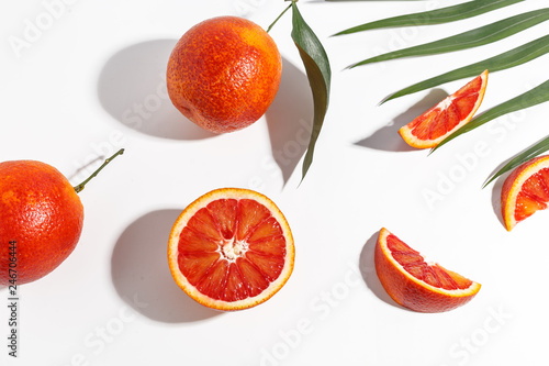 Fototapeta Naklejka Na Ścianę i Meble -  Composition of Sicilian oranges, whole and cut on a white background.