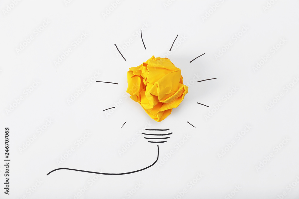 Composition with crumpled paper ball and drawing of lamp bulb on white background, top view. Creative concept - obrazy, fototapety, plakaty 