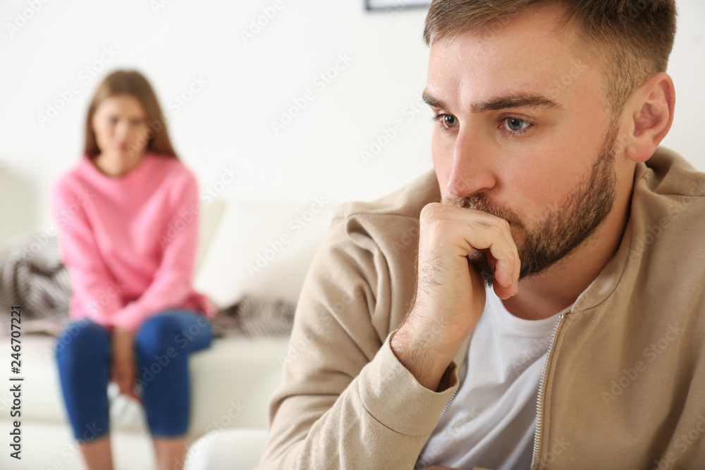 Young couple ignoring each other after argument in living room. Relationship problems Young couple ignoring each other after argument in living room. Relationship problems