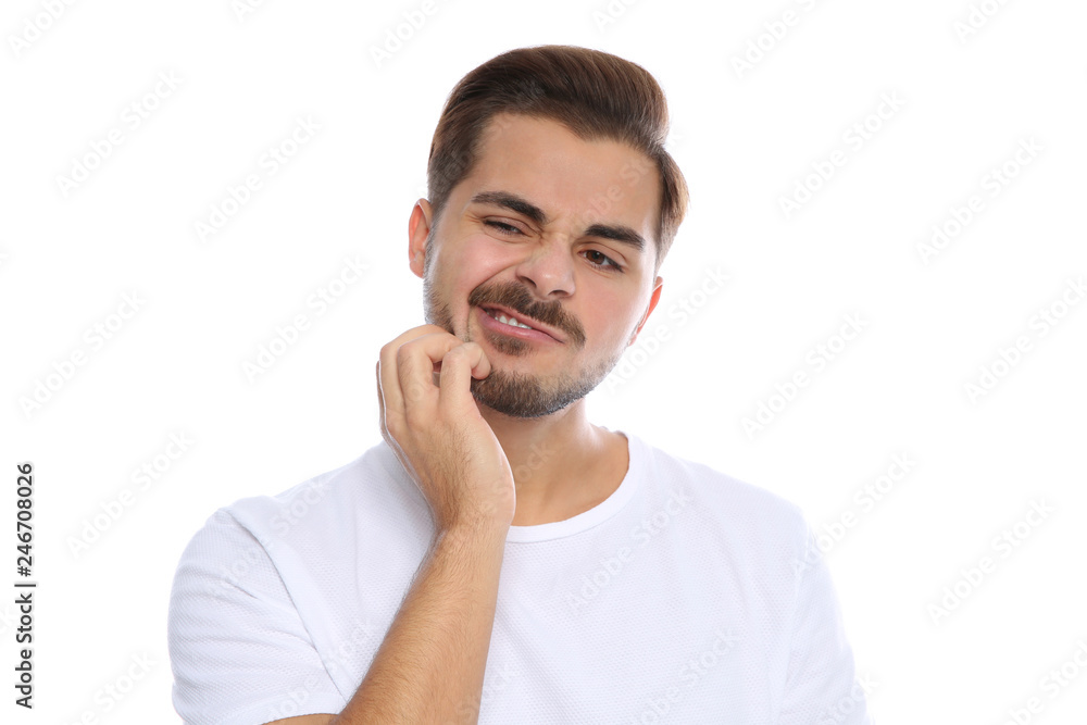 Young man scratching face on white background. Annoying itch Young man scratching face on white background. Annoying itch