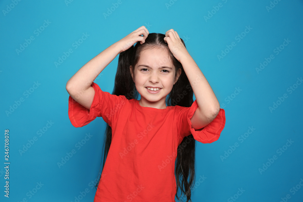 Little girl scratching head on color background. Annoying itch Little girl scratching head on color background. Annoying itch