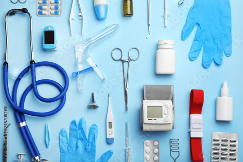 Flat lay composition with medical objects on color background photo