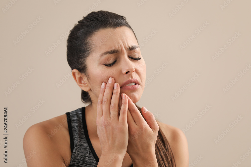 Young woman with sensitive teeth on color background. Space for text Young woman with sensitive teeth on color background. Space for text