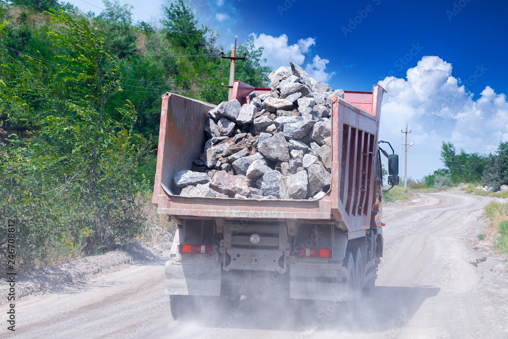 A dump truck loaded mined granite in a quarry open pit mining of