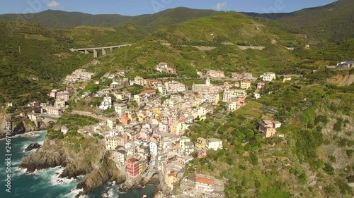 Incredible aerial view of Riomaggoire, Italy tucked in the mountains of Cinque Terre photo