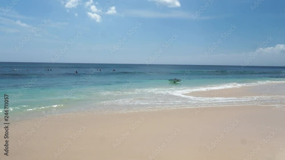 White beach with relaxed people swimming in the sea. White beach with relaxed people swimming in the sea.
