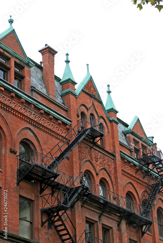 Fototapeta Brick Facade with Fire Escapes