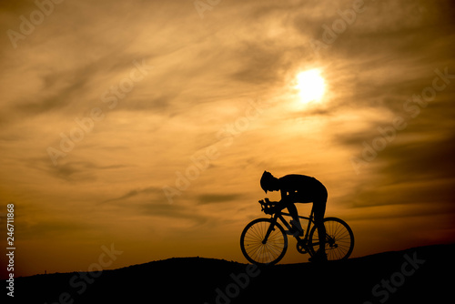 Silhouette cyclist at sunset. © sunti