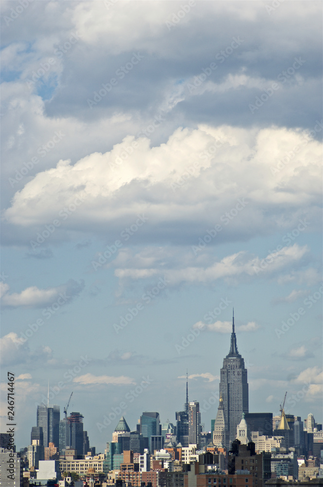 A sweeping view of New York City's midtown Manhattan with some of its iconic buildings, skyscrapers and structures, from the vantage point of Brooklyn Bridge. A sweeping view of New York City's midtown Manhattan with some of its iconic buildings, skyscrapers and structures, from the vantage point of Brooklyn Bridge.