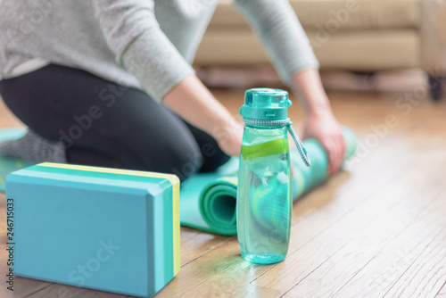 Girl unrolling her yoga mat