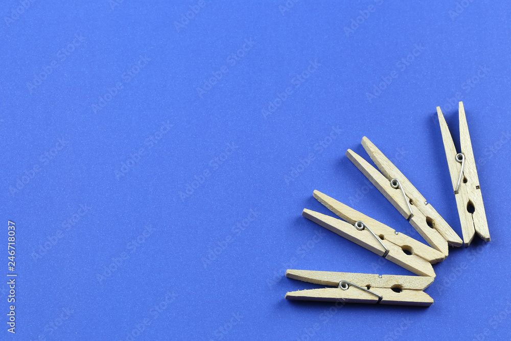 Wooden Clothespin on blue paper background. Wooden Clothespin on blue paper background.