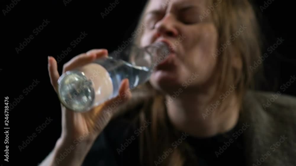 Poor addicted woman greedily drinking alcoholic drink from bottle, ugliness Poor addicted woman greedily drinking alcoholic drink from bottle, ugliness