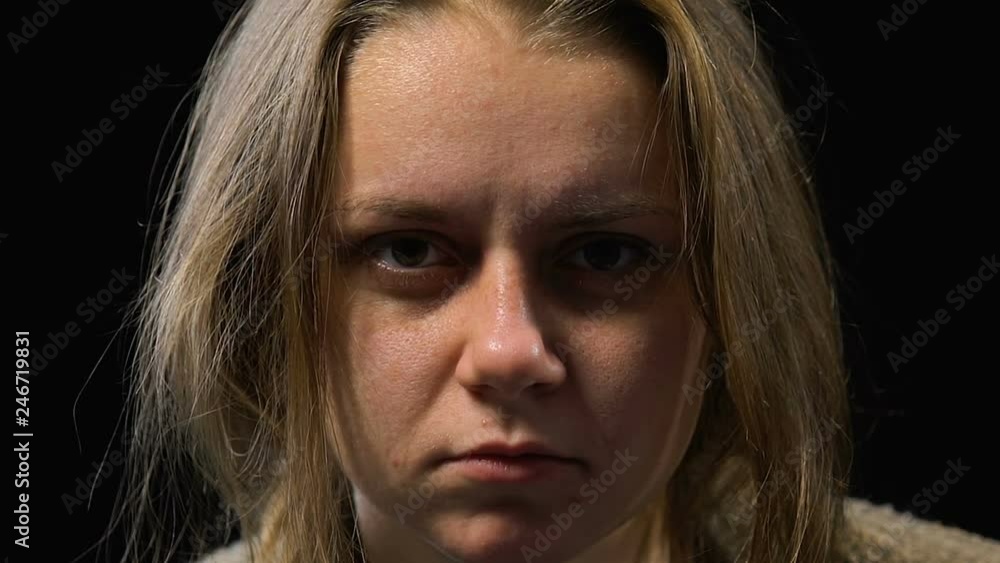 Girl with indifferent empty stare looking into camera, hospital for mentally ill Girl with indifferent empty stare looking into camera, hospital for mentally ill