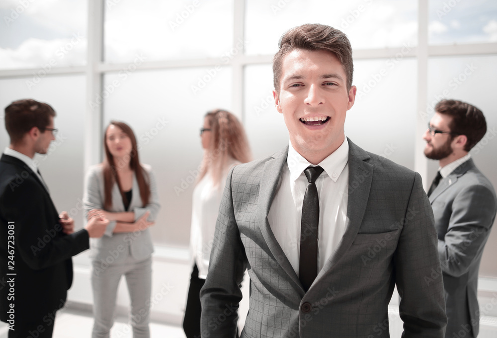 young businessman standing in the office lobby young businessman standing in the office lobby