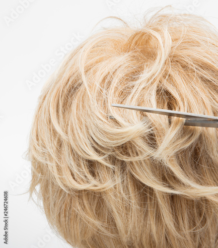 Artificial Fake Hair Wig on Rattan Head Mannequin wooden stand, studio lighting isolated on white gray close up detail of hair copy space text logo, color blonde curl straight top, professional Comb s