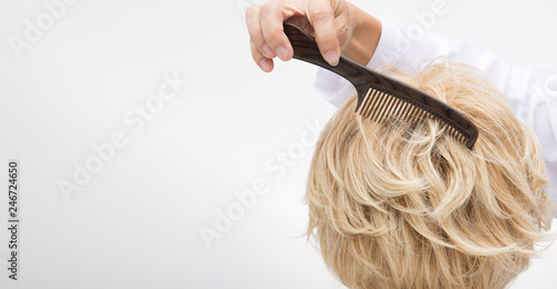 Artificial Fake Hair Wig on Rattan Head Mannequin wooden stand, studio lighting isolated on white gray close up detail of hair copy space text logo, color blonde curl straight top, professional Comb s