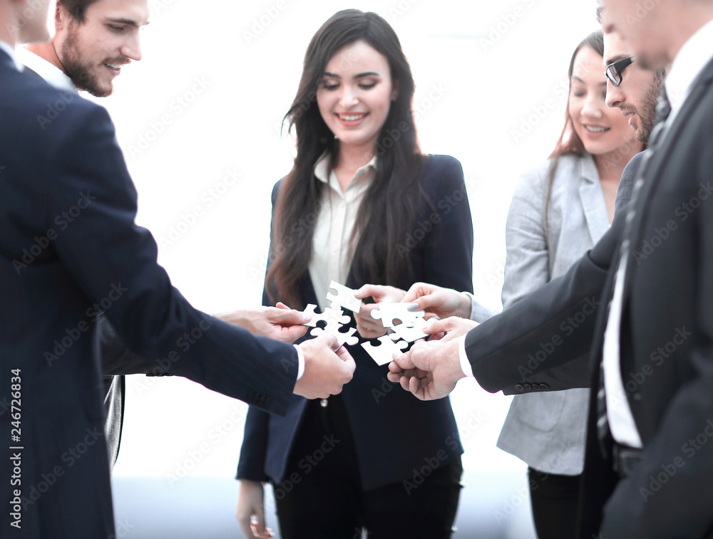 Group of business people assembling jigsaw puzzle, team support Group of business people assembling jigsaw puzzle, team support