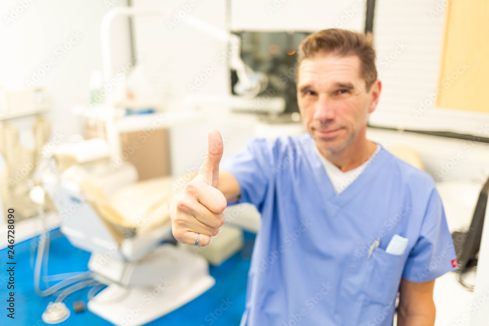 Obraz premium Professional male dentist smiling at camera in office