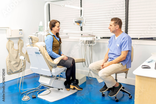 dentist talking to patient, stomatology and health care concept