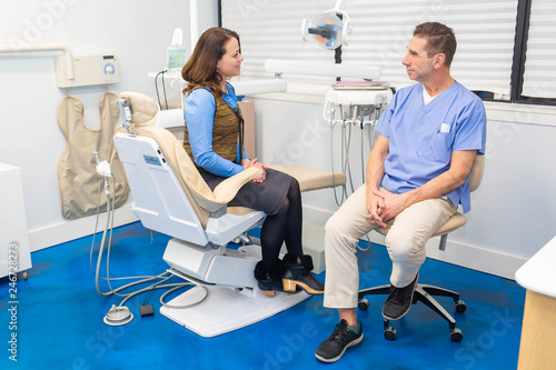 dentist talking to patient, stomatology and health care concept