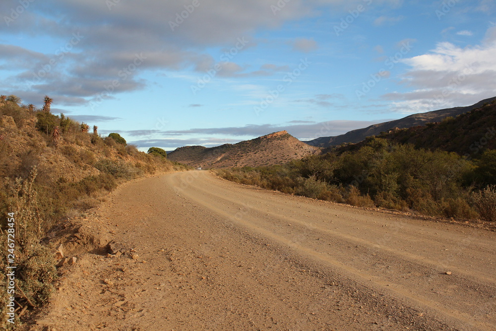 Curved gravel road in the southern Karoo of South Africa.